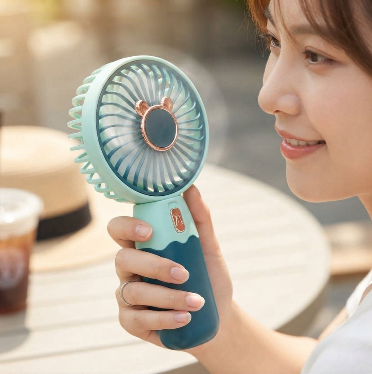 BreezeGo rechargeable handheld fan in use