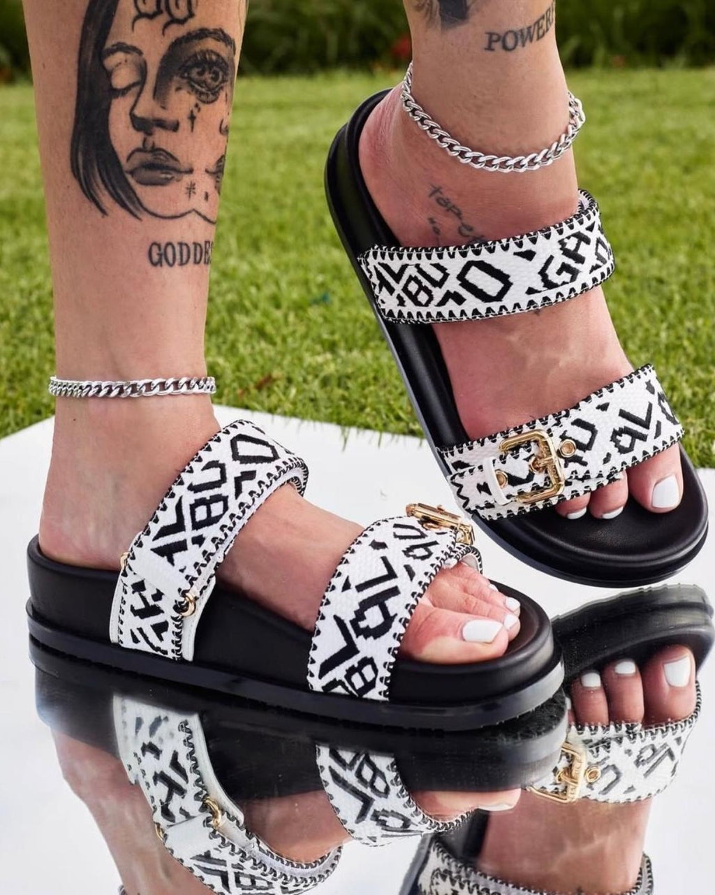 LinkEveryday black and white printed double-strap slide sandals on foot