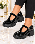 LinkEveryday black patent T-bar platform heels worn as a left and right pair